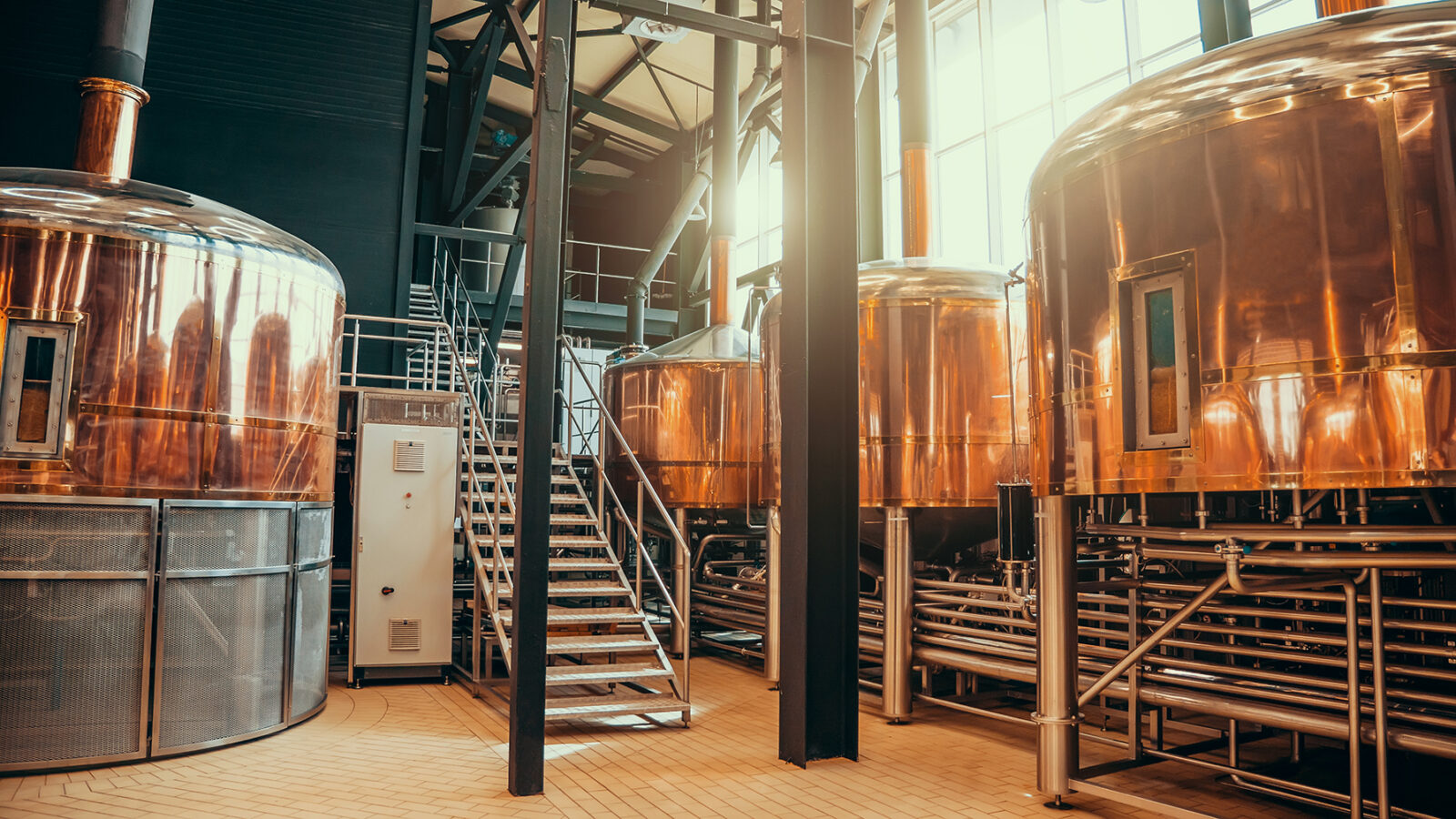 Portrait of Brewery equipment. Brew manufacturing. Round cooper storage tanks for beer fermentation and maturation.